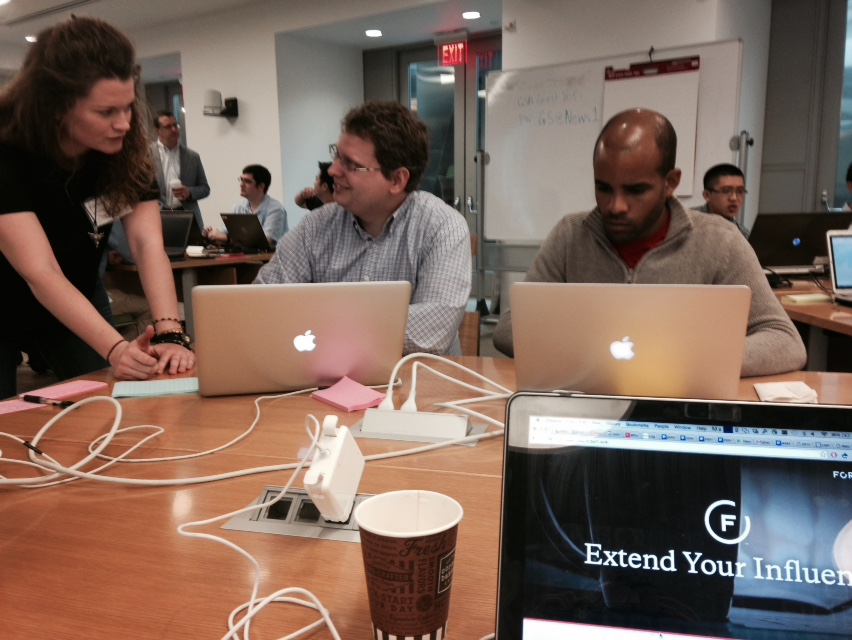 Forum One team working around a table at the GSA Hackathon